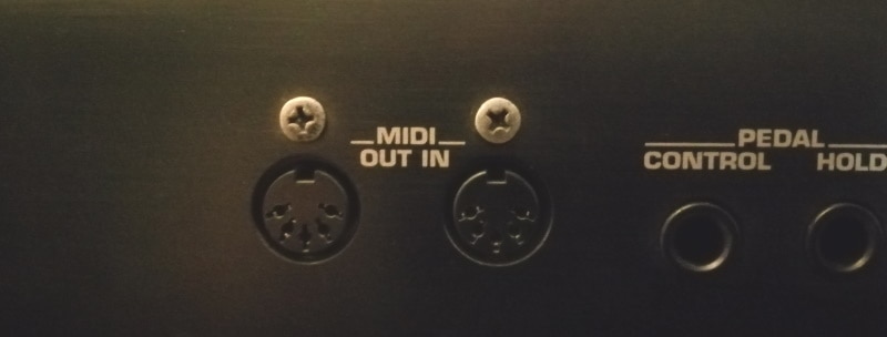 Photo of the 5-pin DIN MIDI ports on a music keyboard