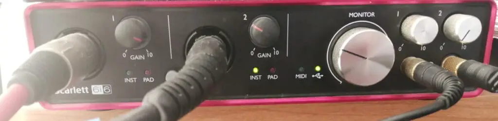 Photo of a Focusrite Scarlett 6i6 audio interface with cables connected to its inputs