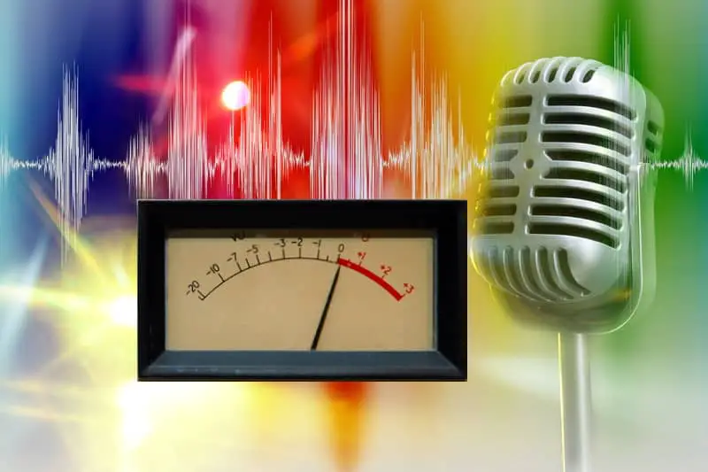 Stylized photo of a VU meter showing 0dB with a retro microphone with a waveform in the background