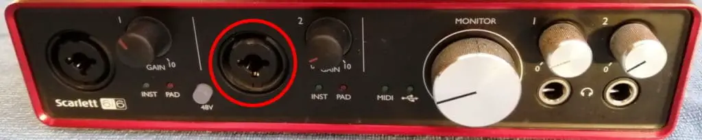 Photo of an audio interface, with one of its inputs highlighted in red