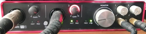 Photo of the front of a Focusrite Scarlett 6i6 audio interface in use
