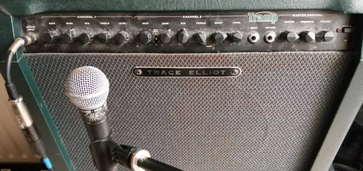 Photo of an SM58 microphone plugged into a Trace Elliot Tramp guitar amp