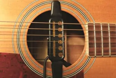 Photo of an acoustic guitar pickup attached to an acoustic guitar